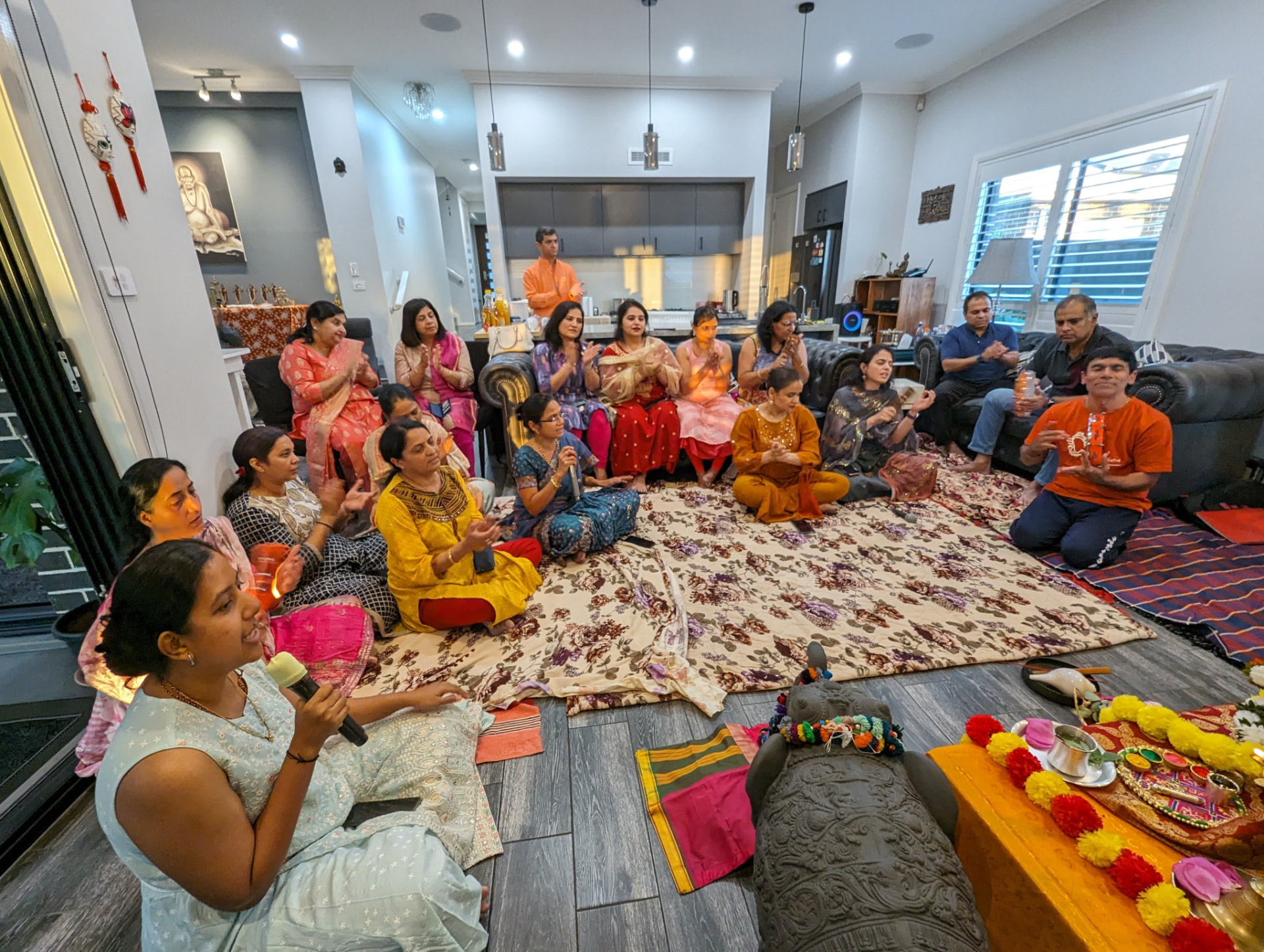 Bhajans sung together, three generations in one room