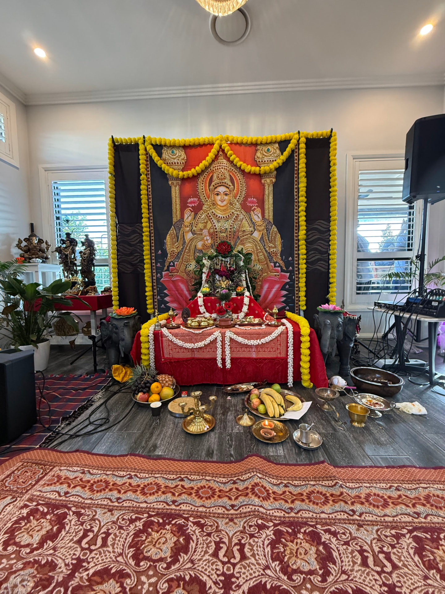 Devi Lakshmi altar with marigold garlands and naivedya, Akshaya Tritiya