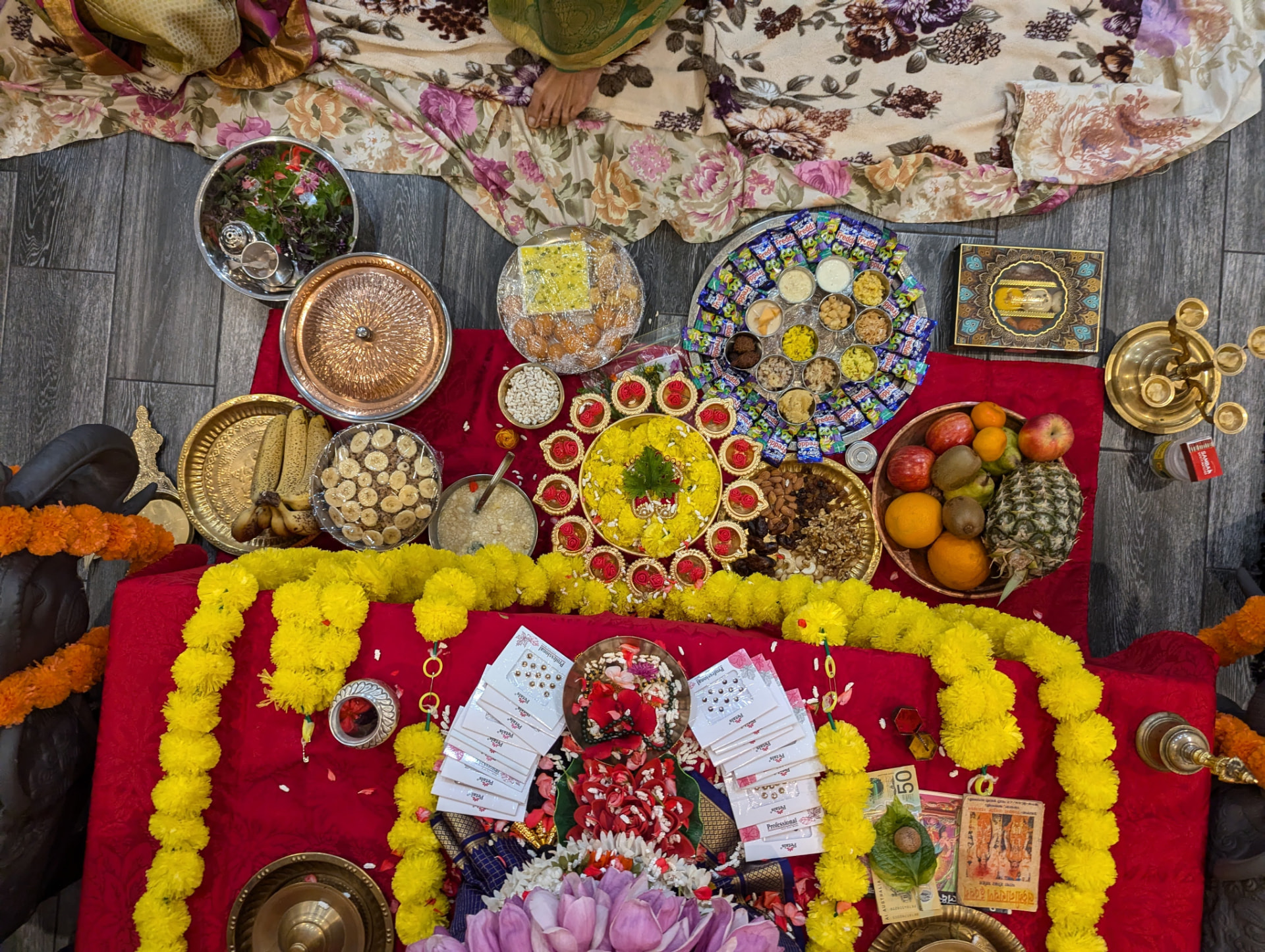 The full naivedya spread — fruits, sweets, dry fruits, panchakajjaya and haldi-kumkum for every woman present