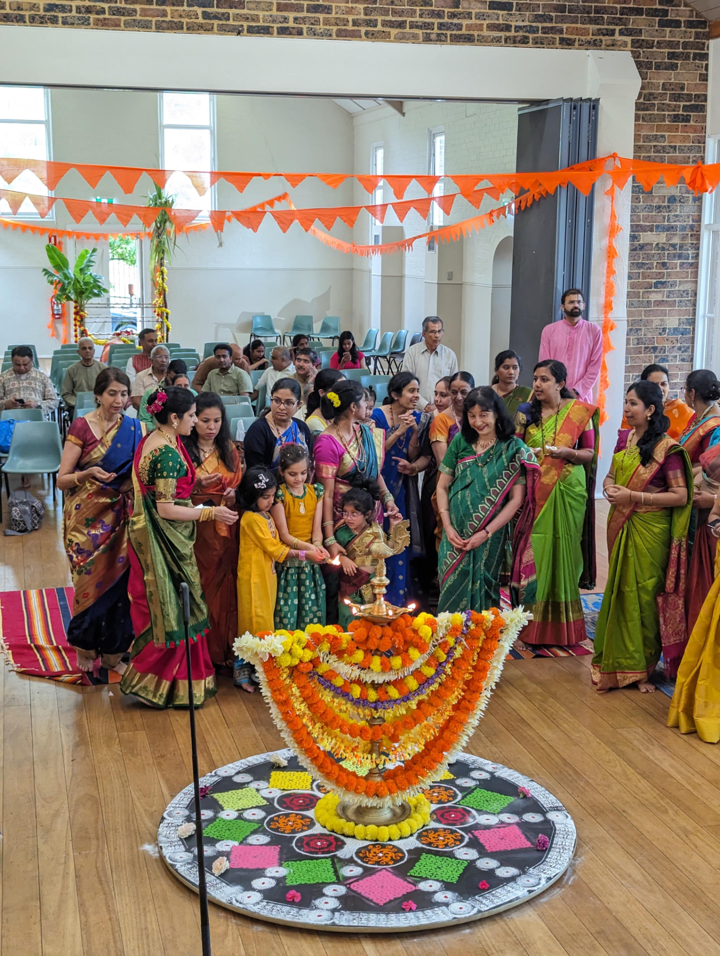 Konkani family lighting diyas together at home