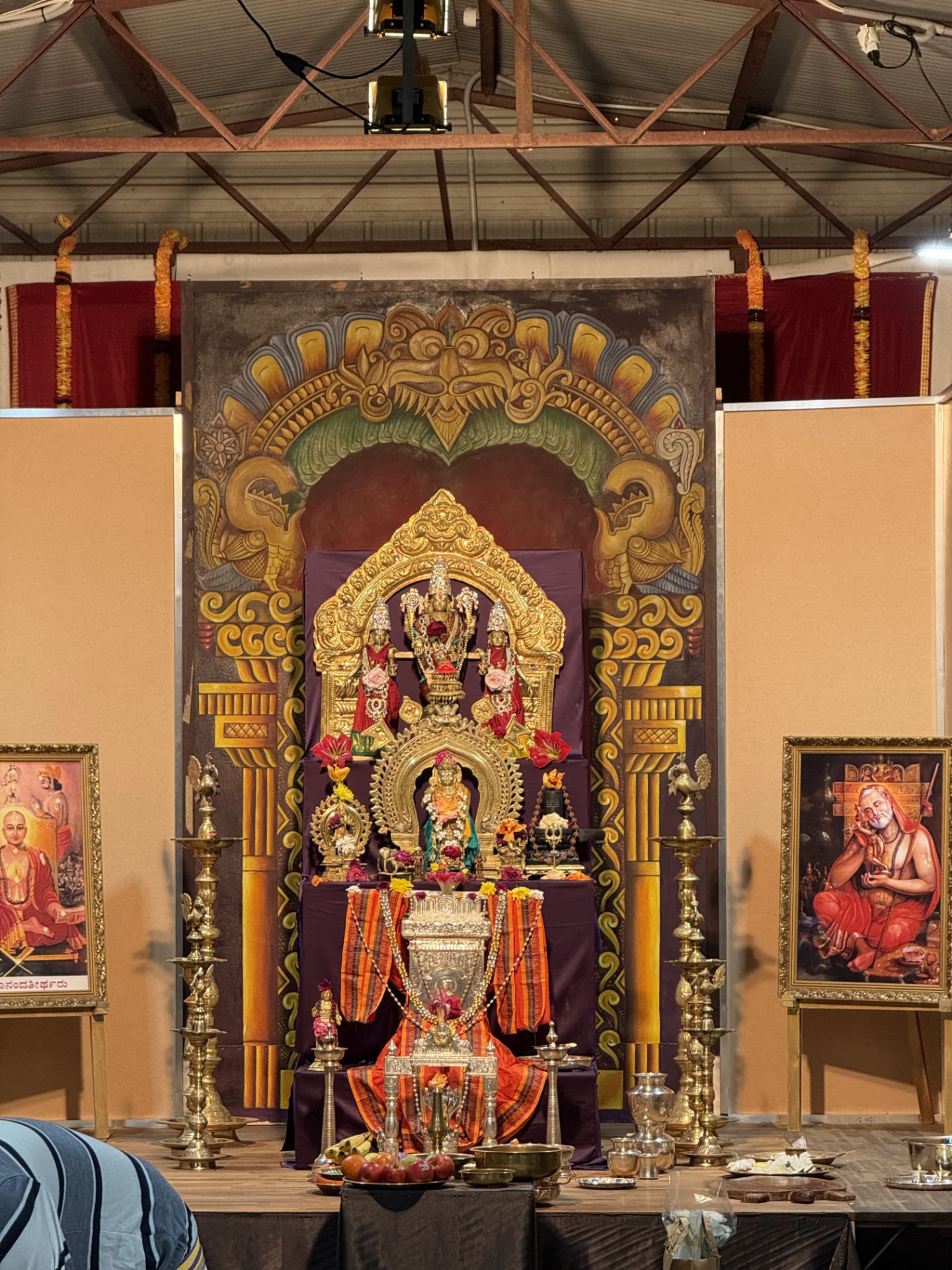 The Vrundavana shrine at Sri Venkata Krishna Vrundavana, Sydney — lamps lit and marigold torans hung for Navaratri